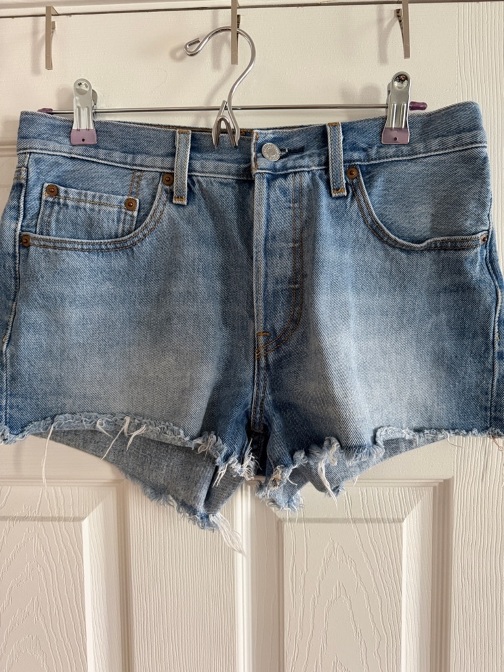 Mid-Rise Light Blue Denim Cutoff Shorts with Frayed Hem